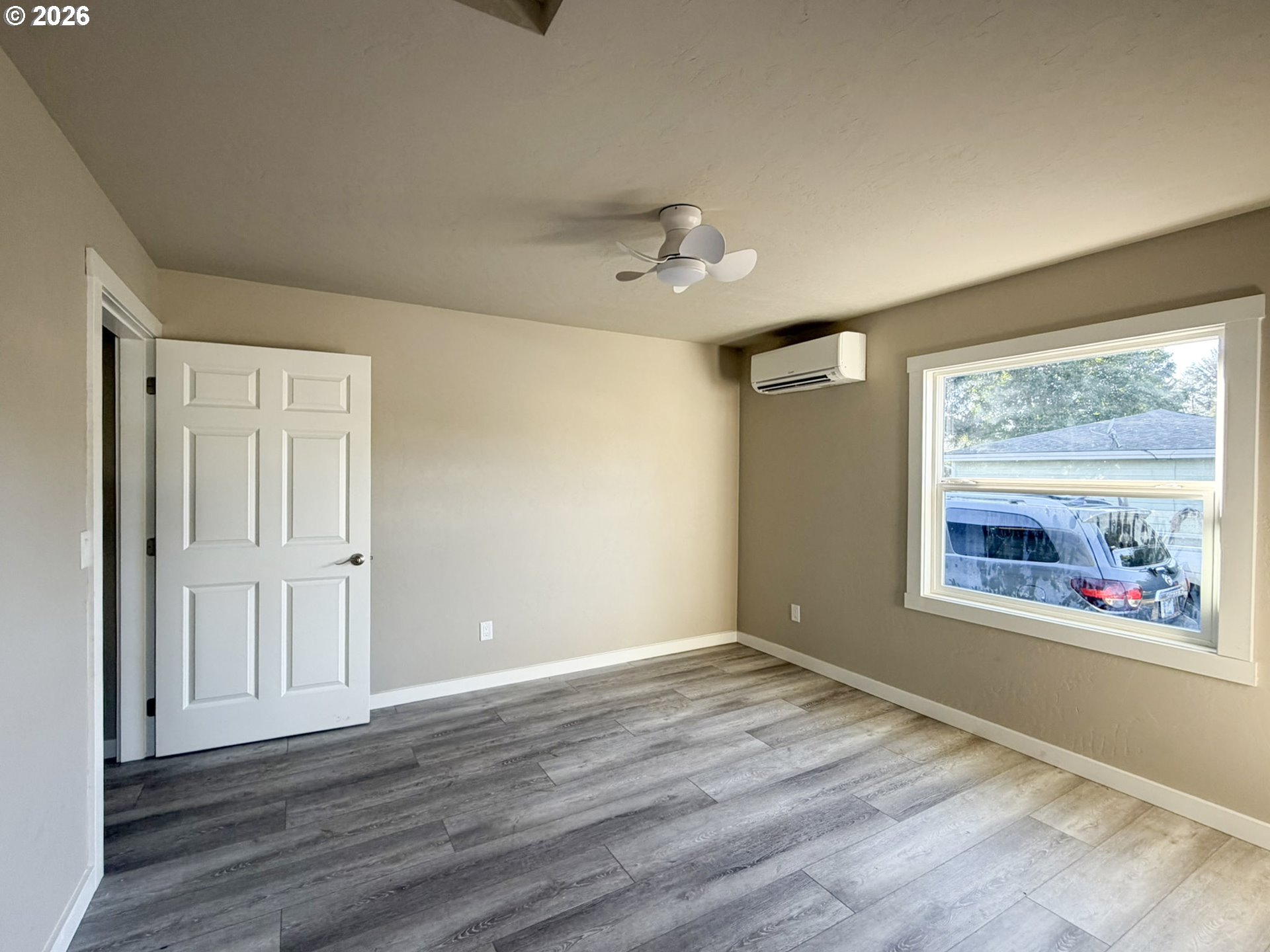 325 Railroad Street Brookings, OR 97415 - Photo 24 of 38 a view of an empty room with a window and wooden floor