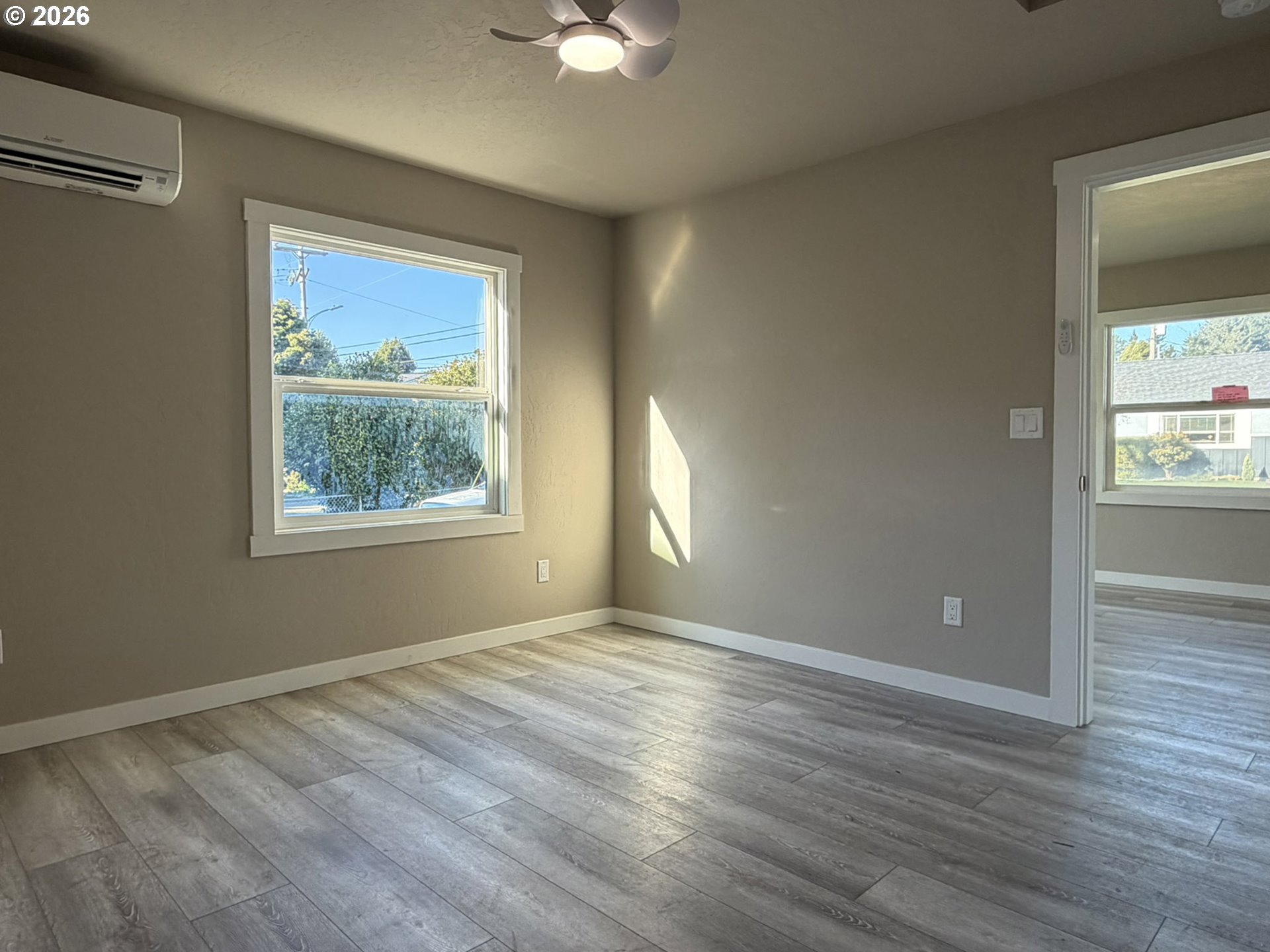 325 Railroad Street Brookings, OR 97415 - Photo 26 of 38 a view of an empty room with wooden floor and a window