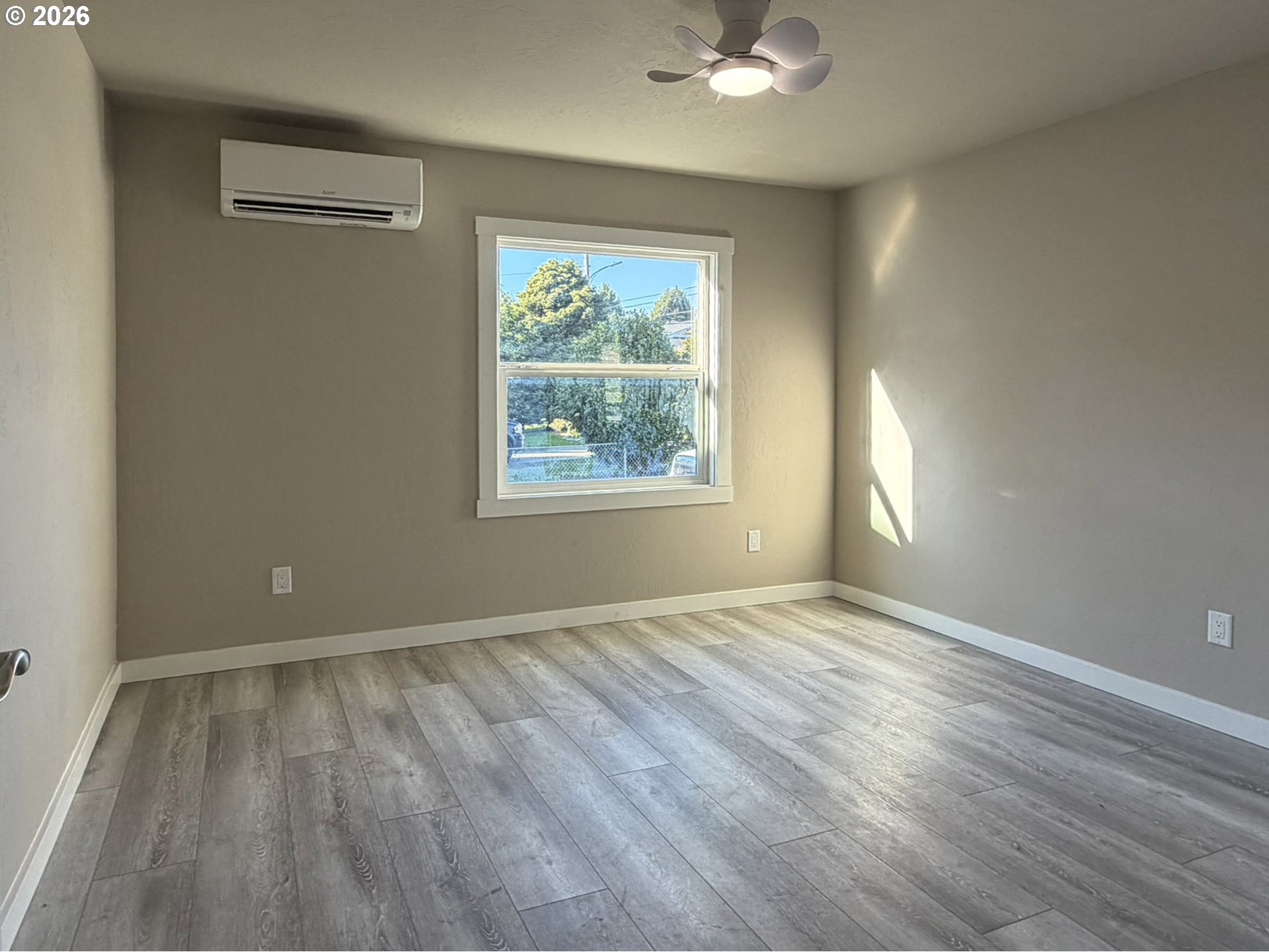 325 Railroad Street Brookings, OR 97415 - Photo 27 of 38 wooden floor in an empty room with a window