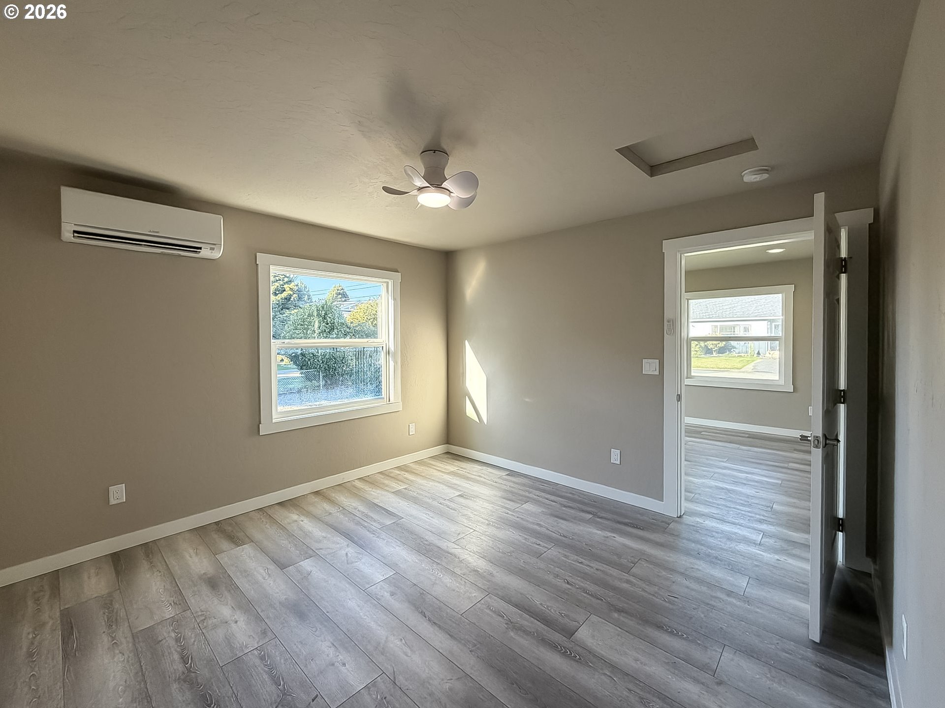 325 Railroad Street Brookings, OR 97415 - Photo 31 of 38 a view of an empty room with wooden floor and a window