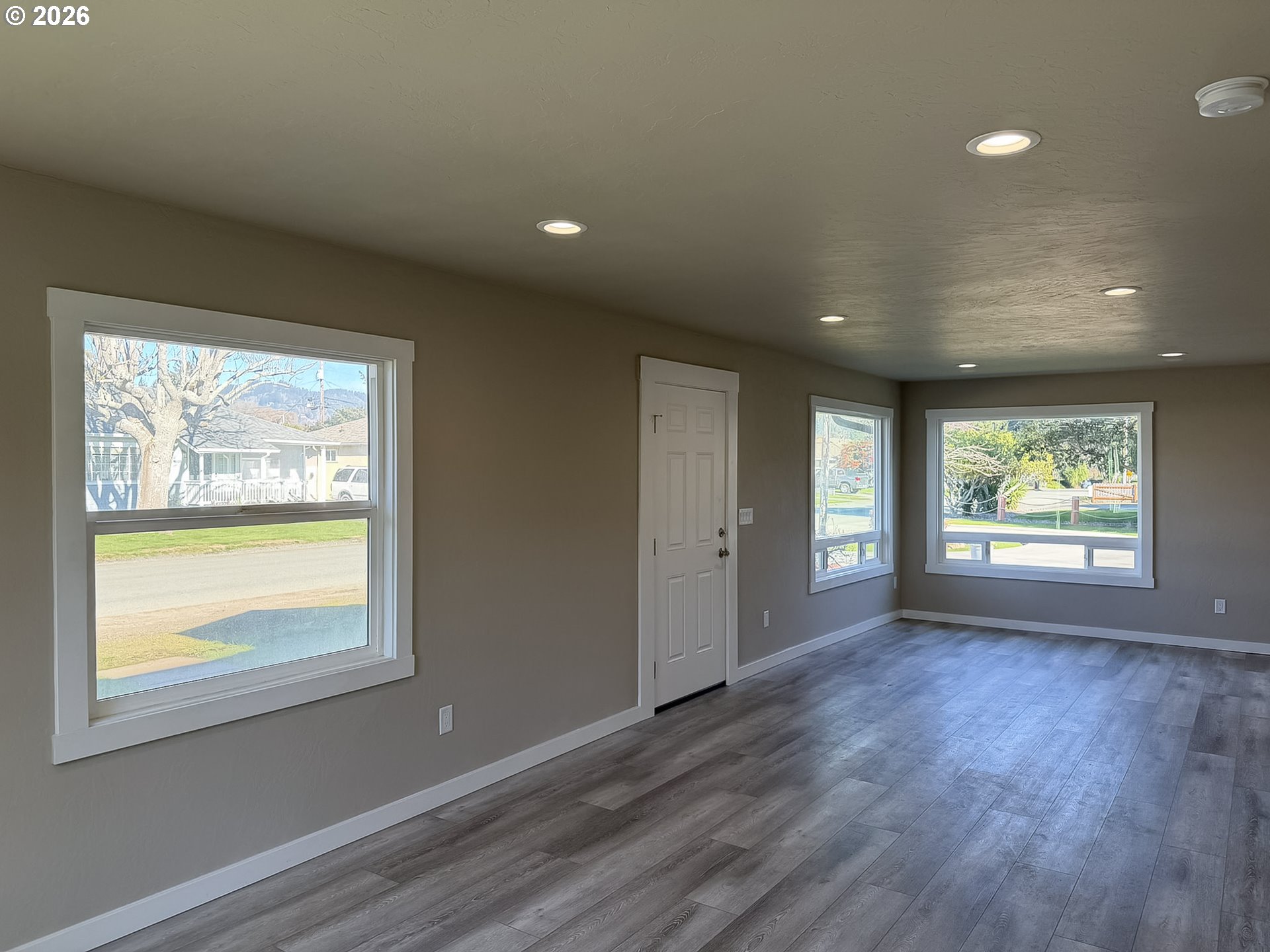 325 Railroad Street Brookings, OR 97415 - Photo 33 of 38 a view of an empty room with wooden floor and a window