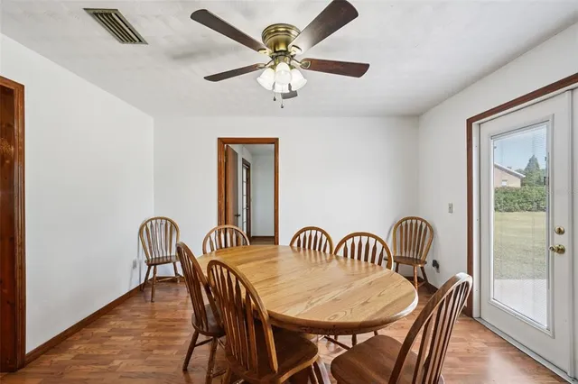 an empty room with a window and ceiling fan