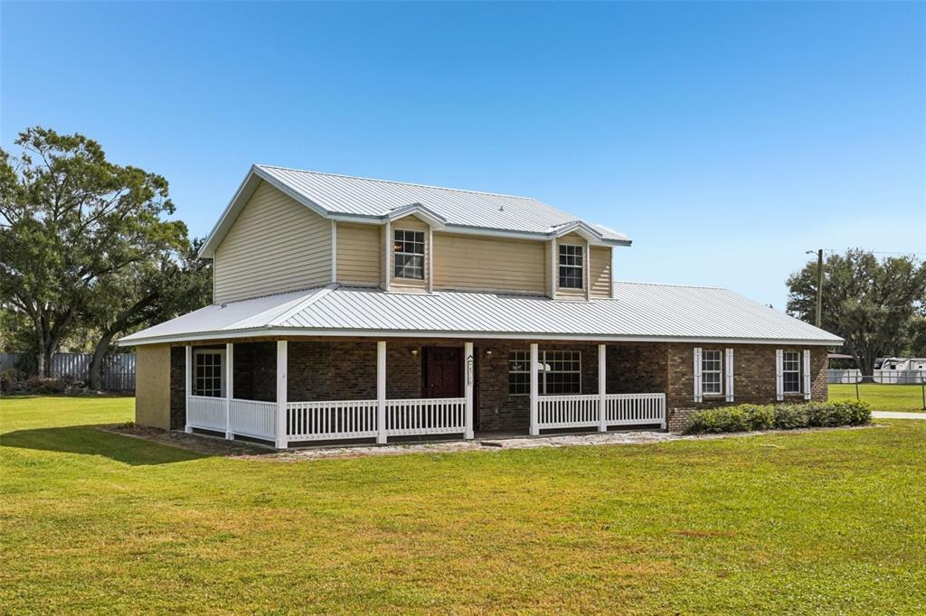 4716 Gallagher Road Plant City, FL 33565 - Photo 2 of 69 a front view of a house with a large window and plants