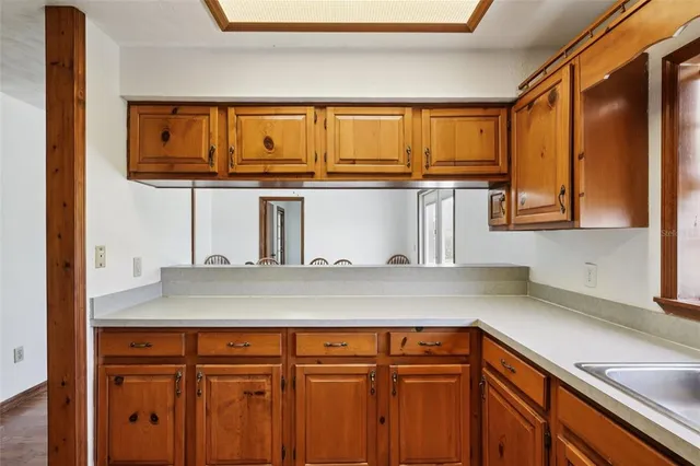 a bathroom with a granite countertop sink and a large mirror