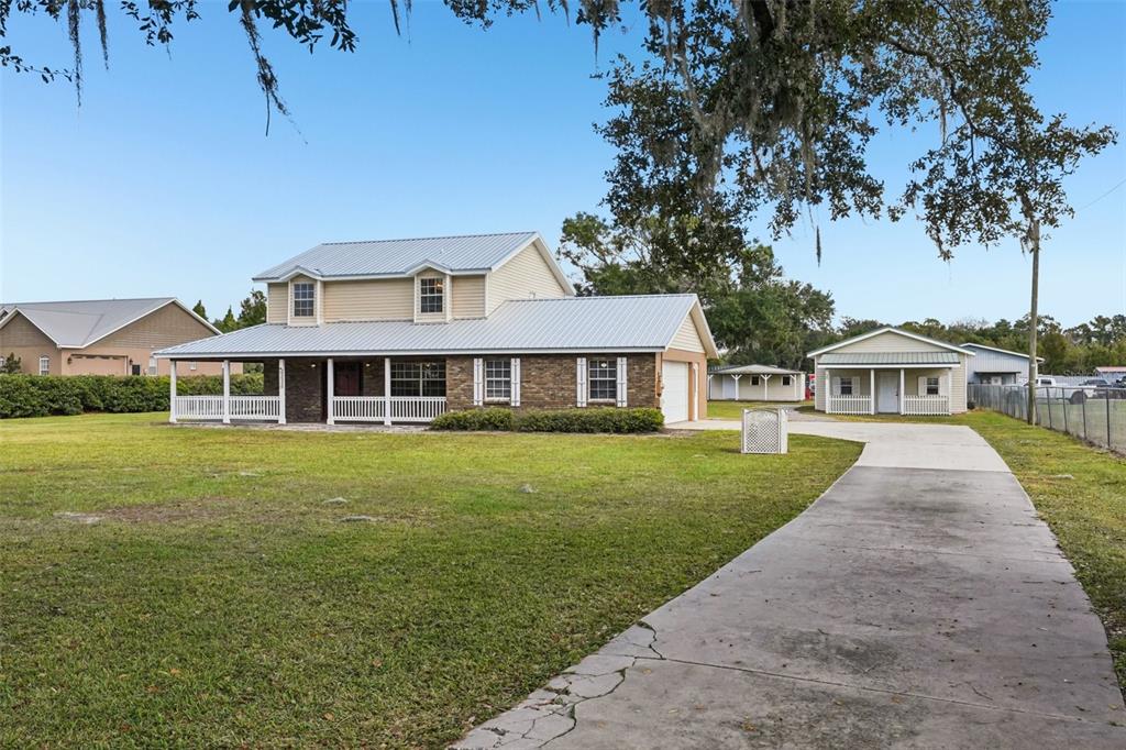 4716 Gallagher Road Plant City, FL 33565 - Photo 3 of 69 a front view of a house with a garden