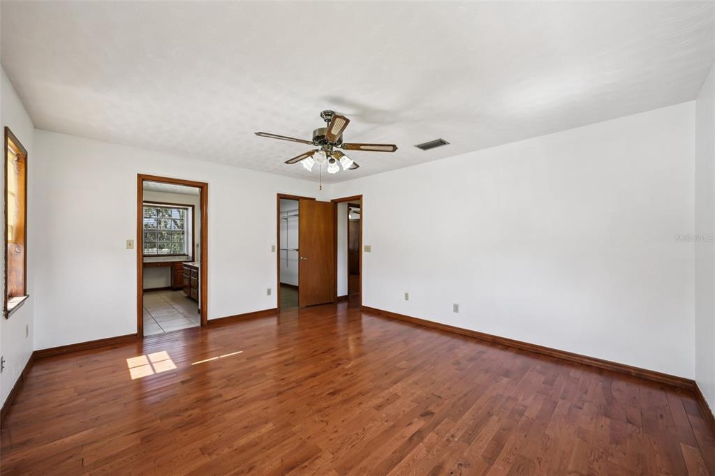 4716 Gallagher Road Plant City, FL 33565 - Photo 35 of 69 a view of an empty room with wooden floor and a window