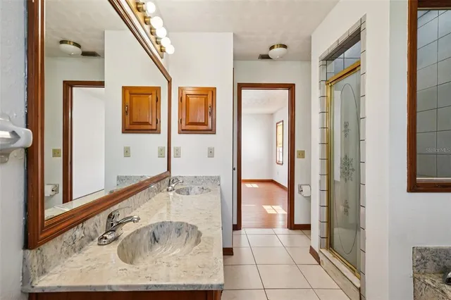 a view of a house with a yard balcony and a small yard