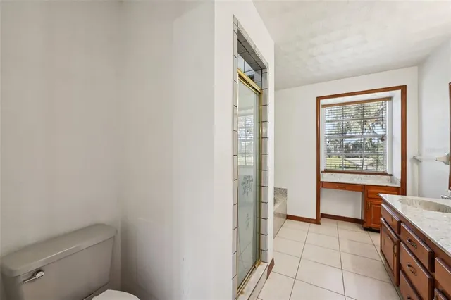 an empty room with windows and cabinet