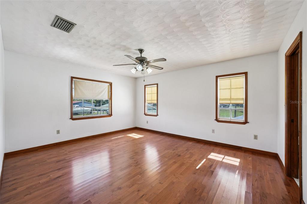 4716 Gallagher Road Plant City, FL 33565 - Photo 44 of 69 a view of an empty room with wooden floor and a window