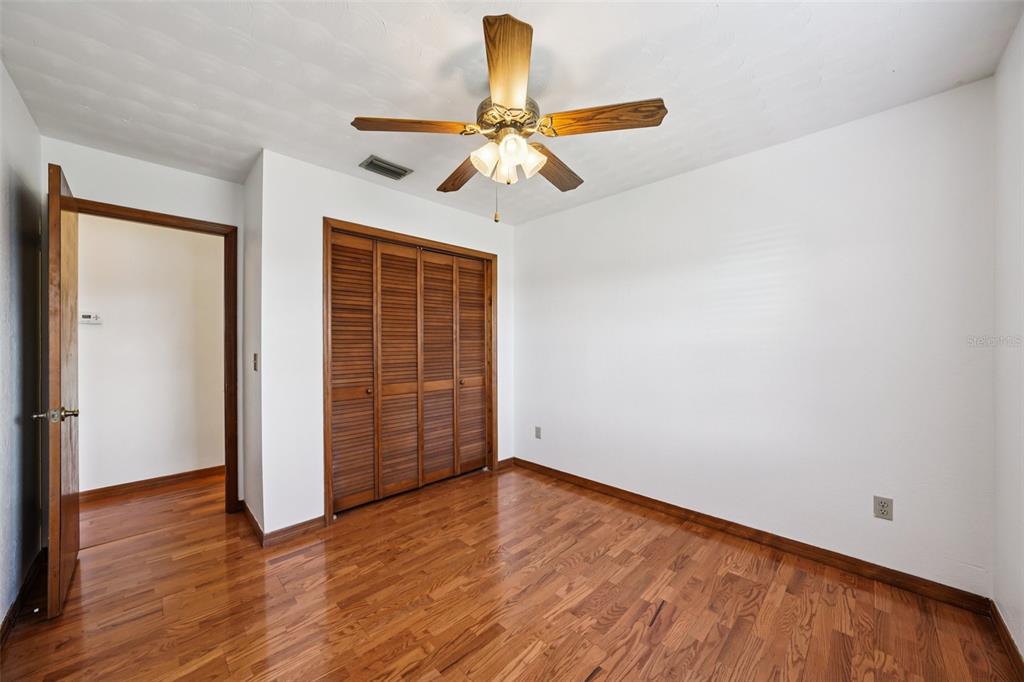 4716 Gallagher Road Plant City, FL 33565 - Photo 49 of 69 a view of empty room with wooden floor and ceiling fan