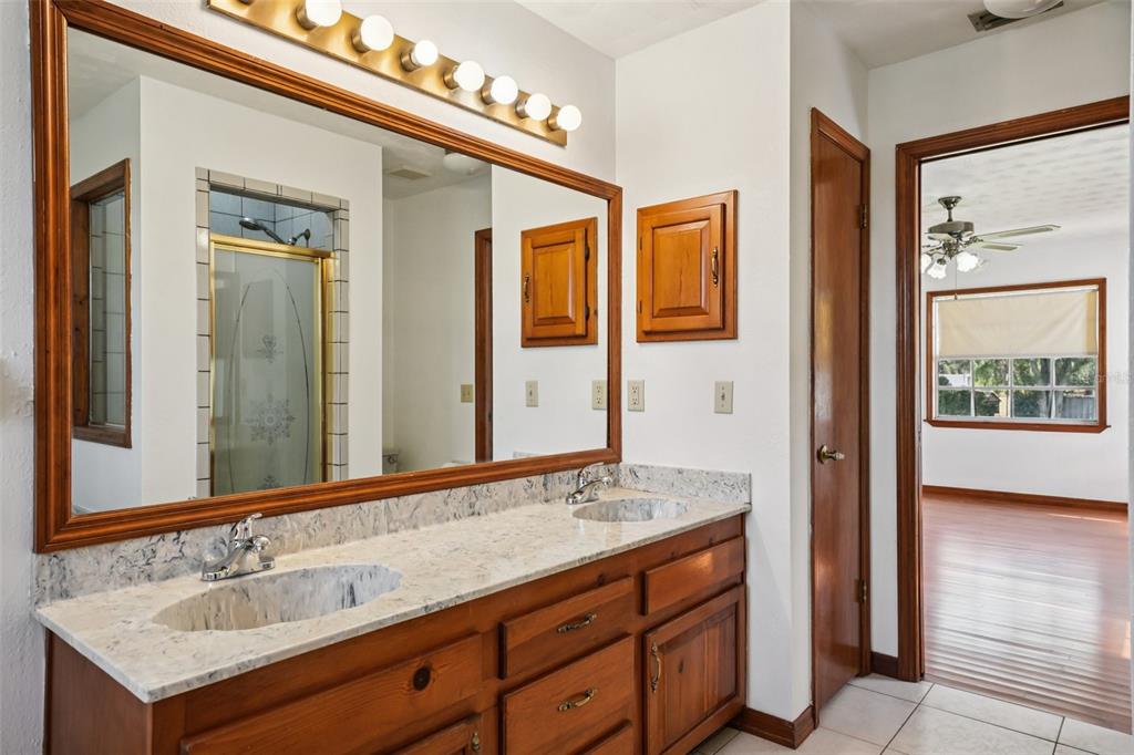 4716 Gallagher Road Plant City, FL 33565 - Photo 50 of 69 a bathroom with a sink double vanity and a mirror