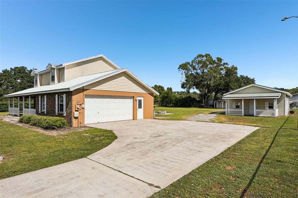 4716 Gallagher Road Plant City, FL 33565 - Photo 5 of 69 a front view of a house with a yard and garage