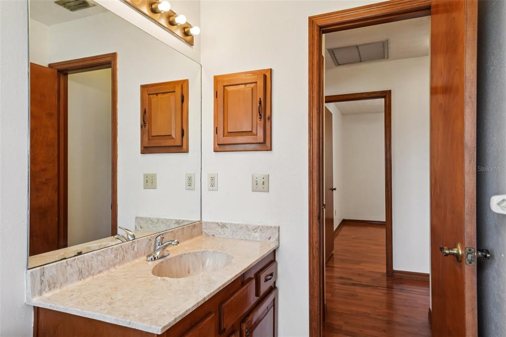 4716 Gallagher Road Plant City, FL 33565 - Photo 51 of 69 a bathroom with a granite countertop sink and a mirror