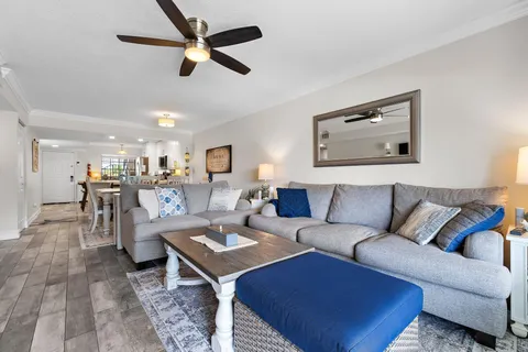 a living room with furniture kitchen view and a table