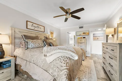 a bedroom with a large bed and a chandelier