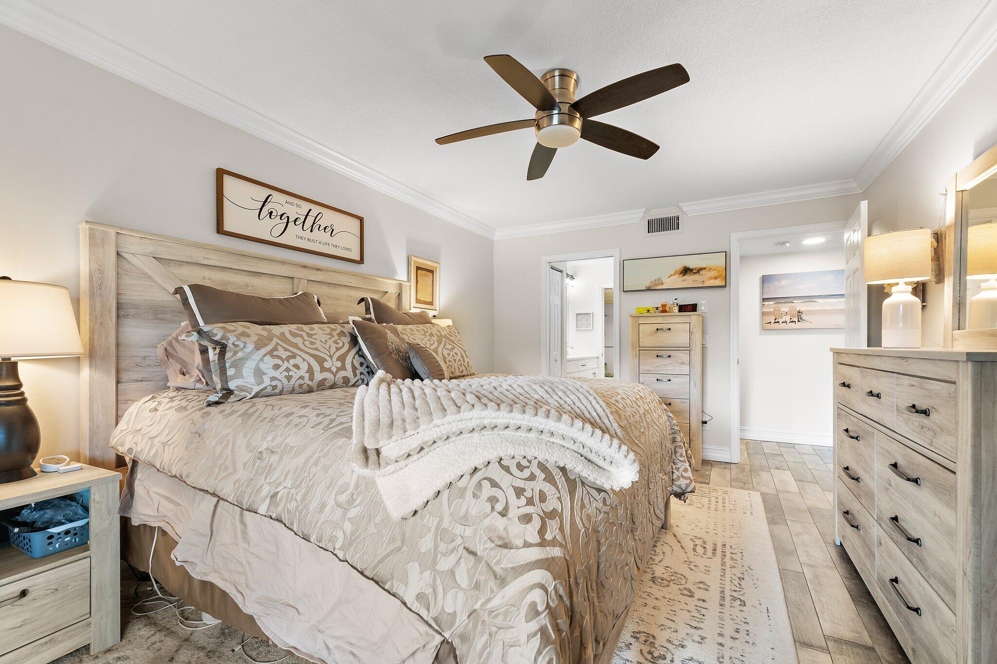 1201 Pinecrest Circle, Unit B Jupiter, FL 33458 - Photo 20 of 39 a bedroom with a large bed and a chandelier