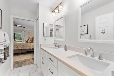 a en suite bathroom with a double sink and mirror