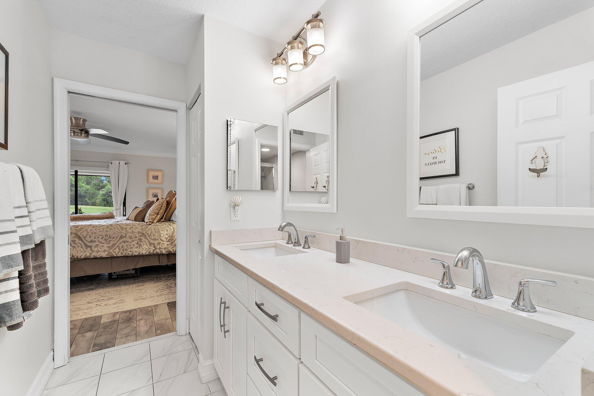 1201 Pinecrest Circle, Unit B Jupiter, FL 33458 - Photo 23 of 39 a en suite bathroom with a double sink and mirror