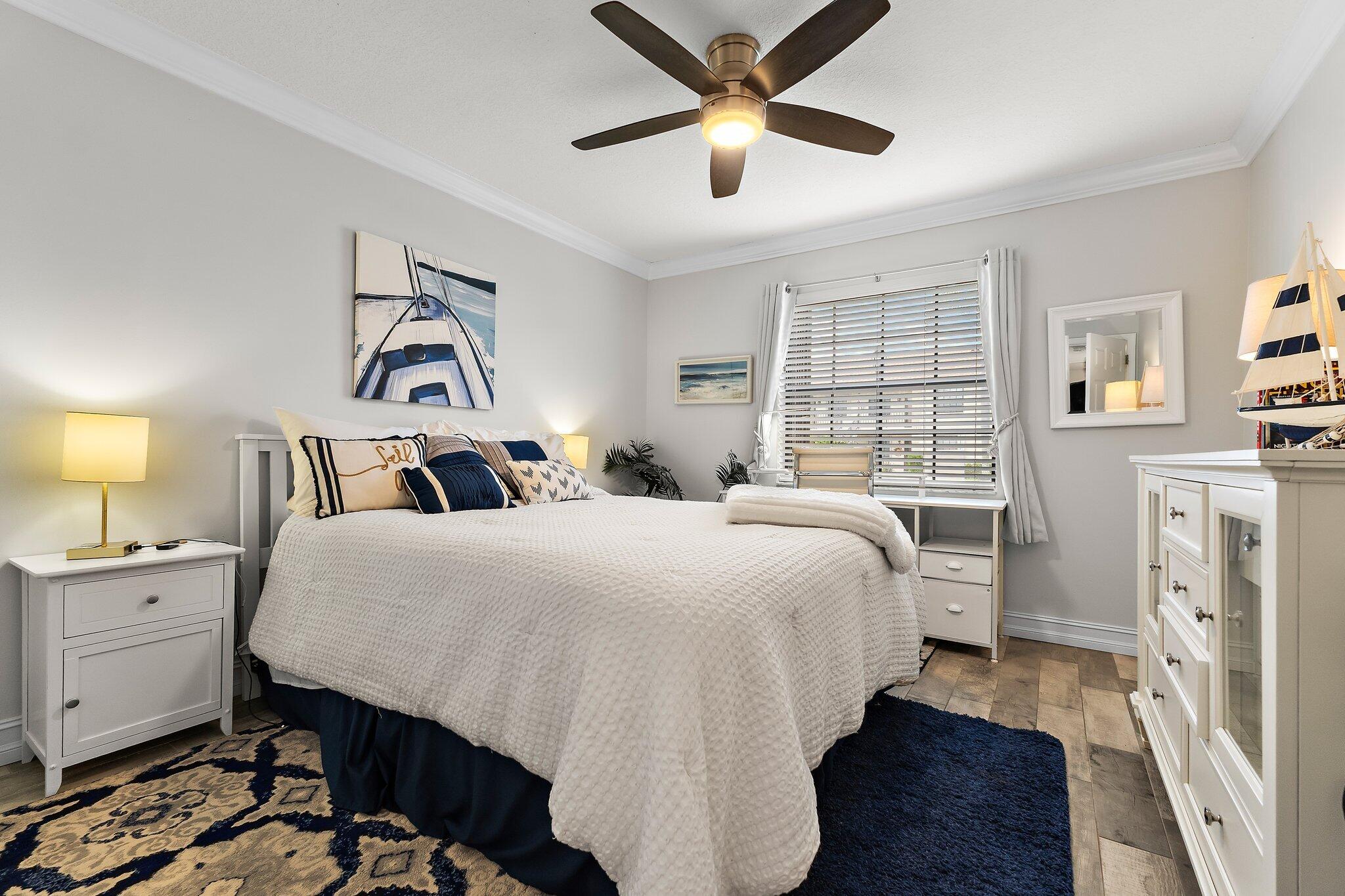 1201 Pinecrest Circle, Unit B Jupiter, FL 33458 - Photo 26 of 39 a bedroom with a bed and a chandelier