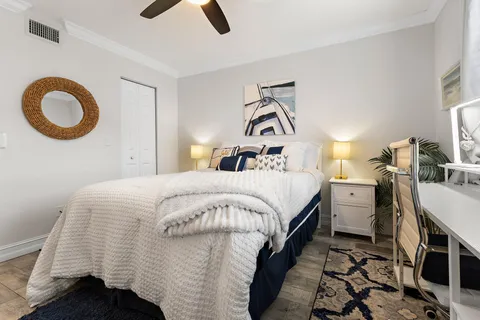 a bedroom with a bed and a chandelier