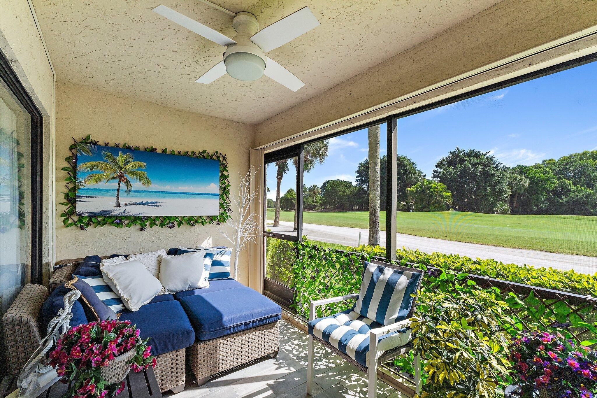 1201 Pinecrest Circle, Unit B Jupiter, FL 33458 - Photo 35 of 39 a living room with furniture and a floor to ceiling window