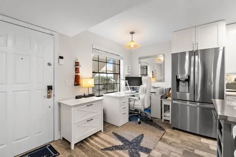 a kitchen with white cabinets and stainless steel appliances
