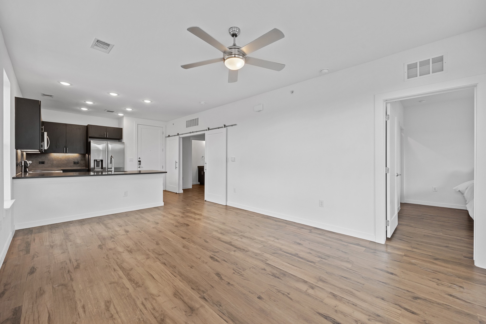 4801 Springdale Road, Unit 2301 Austin, TX 78723 - Photo 10 of 36 A contemporary open-concept layout unites the sleek kitchen with the living area, creating an inviting space.