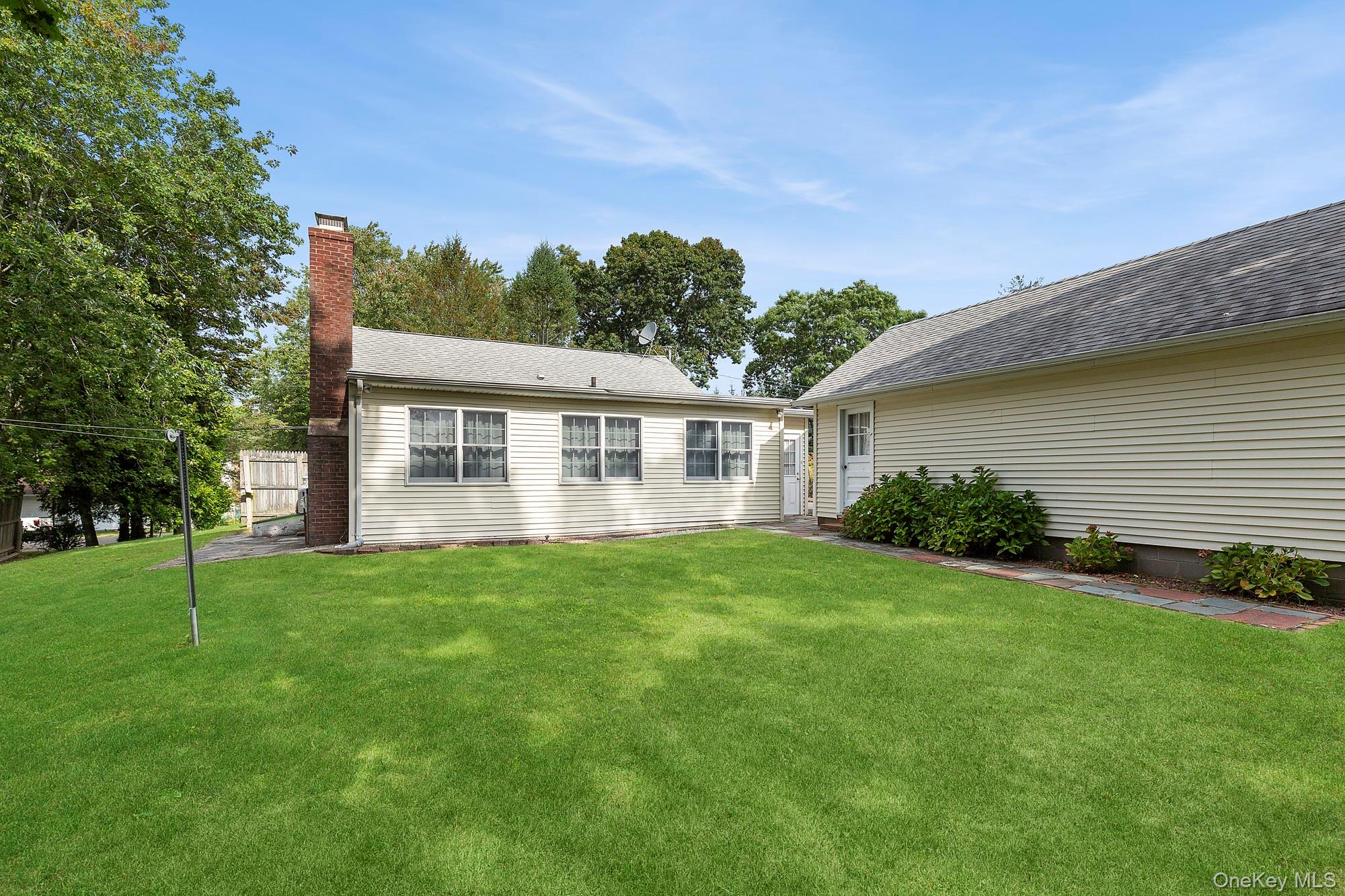 1645 Ruth Road Mattituck, NY 11952 - Photo 12 of 16 a view of a house with a backyard