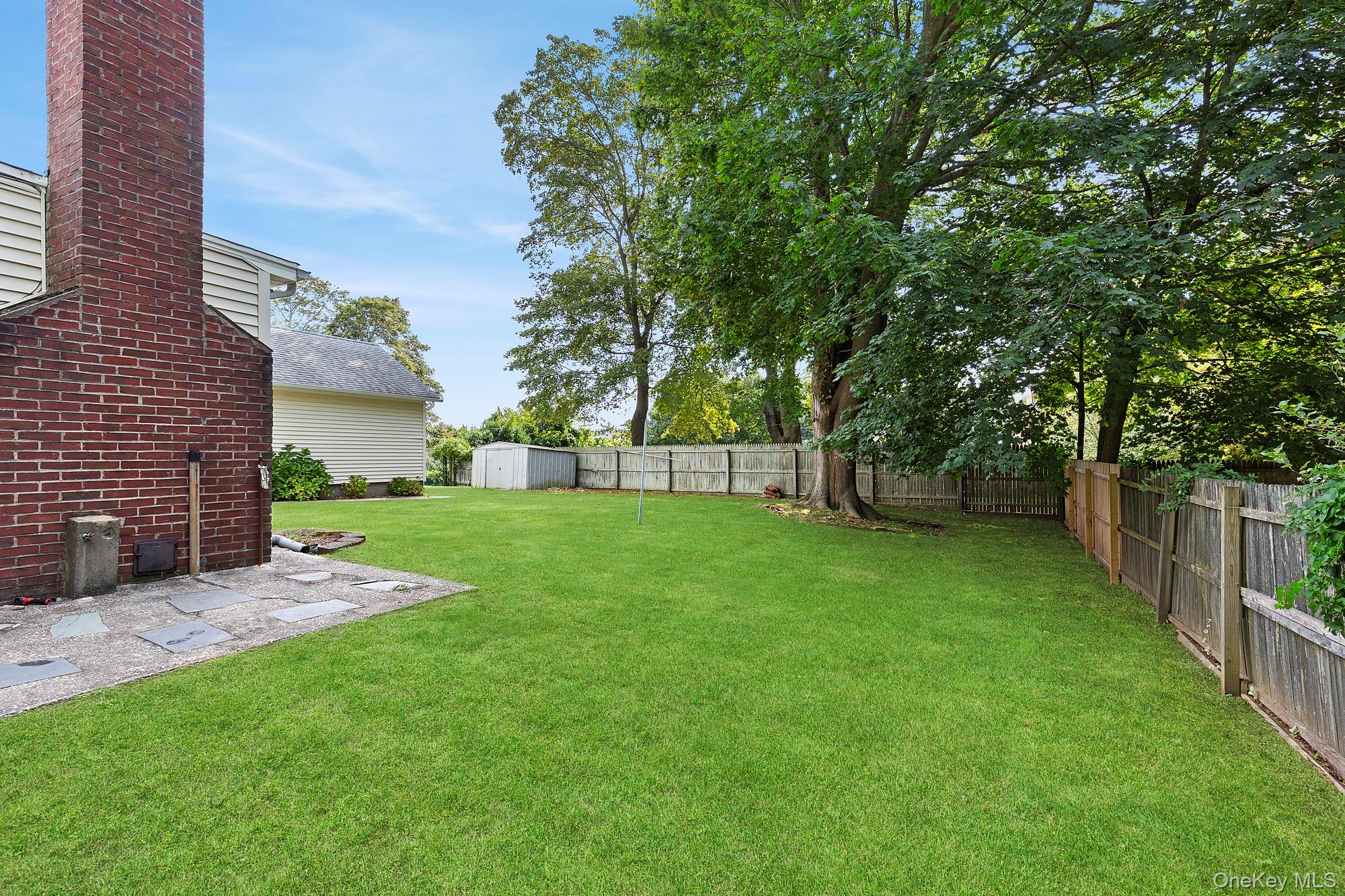 1645 Ruth Road Mattituck, NY 11952 - Photo 13 of 16 a view of a yard with a tree