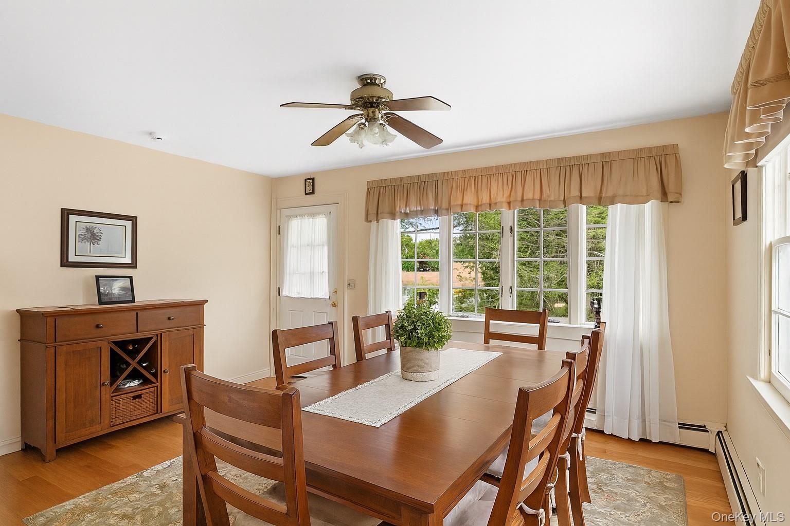 1645 Ruth Road Mattituck, NY 11952 - Photo 5 of 16 a dining room with furniture a chandelier and wooden floor