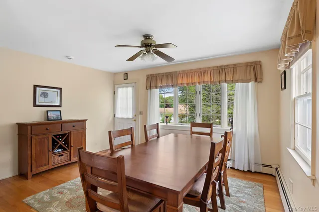 a view of a dining room with furniture window and wooden floor
