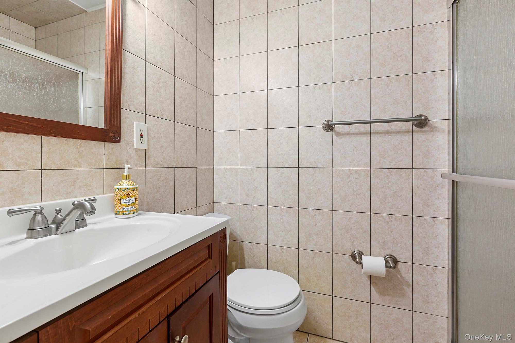1645 Ruth Road Mattituck, NY 11952 - Photo 10 of 16 a bathroom with a sink toilet and shower
