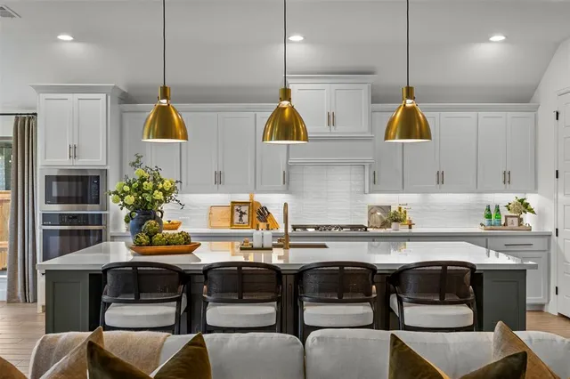 a kitchen with a table chairs sink and cabinets
