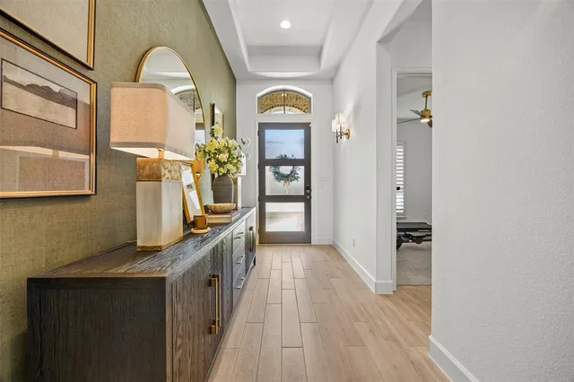 a view of a hallway view with wooden floor and staircase