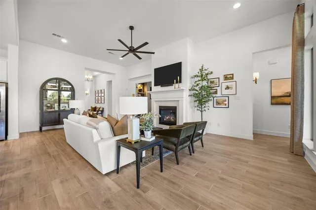 a living room with furniture a fireplace and a flat screen tv