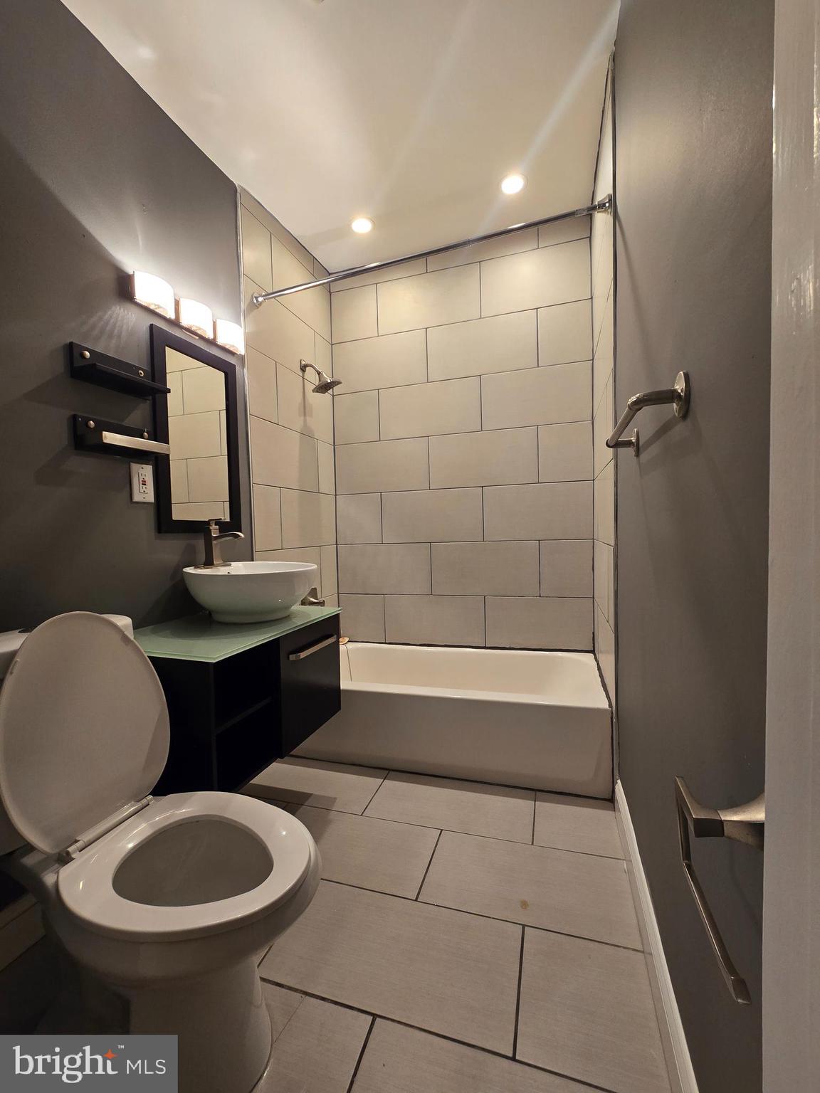 4044 7th Street Northeast, Unit 2 Washington, DC 20017 - Photo 5 of 8 a bathroom with a toilet a sink and bathtub