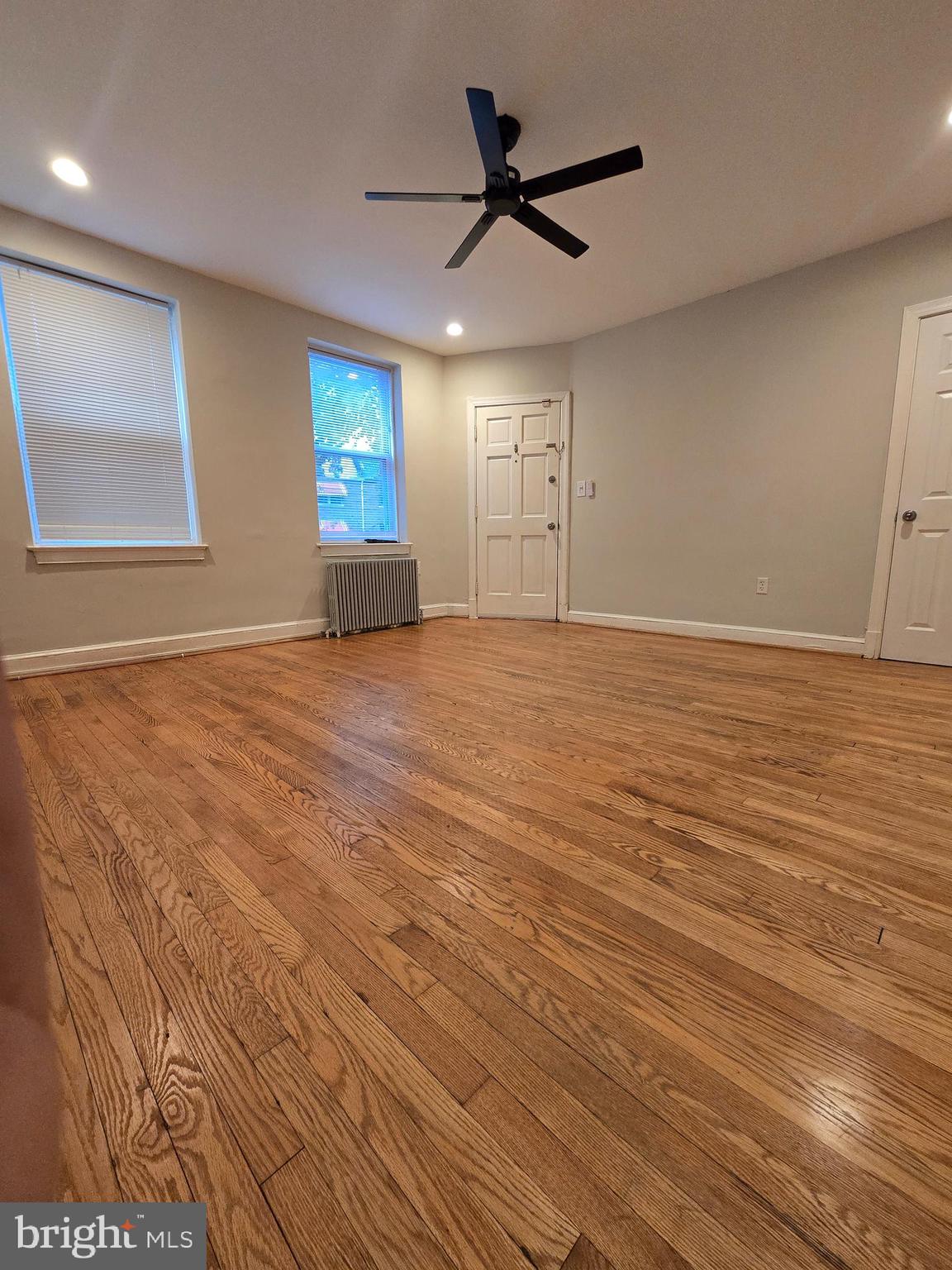 4044 7th Street Northeast, Unit 2 Washington, DC 20017 - Photo 8 of 8 a view of an empty room with window and wooden floor