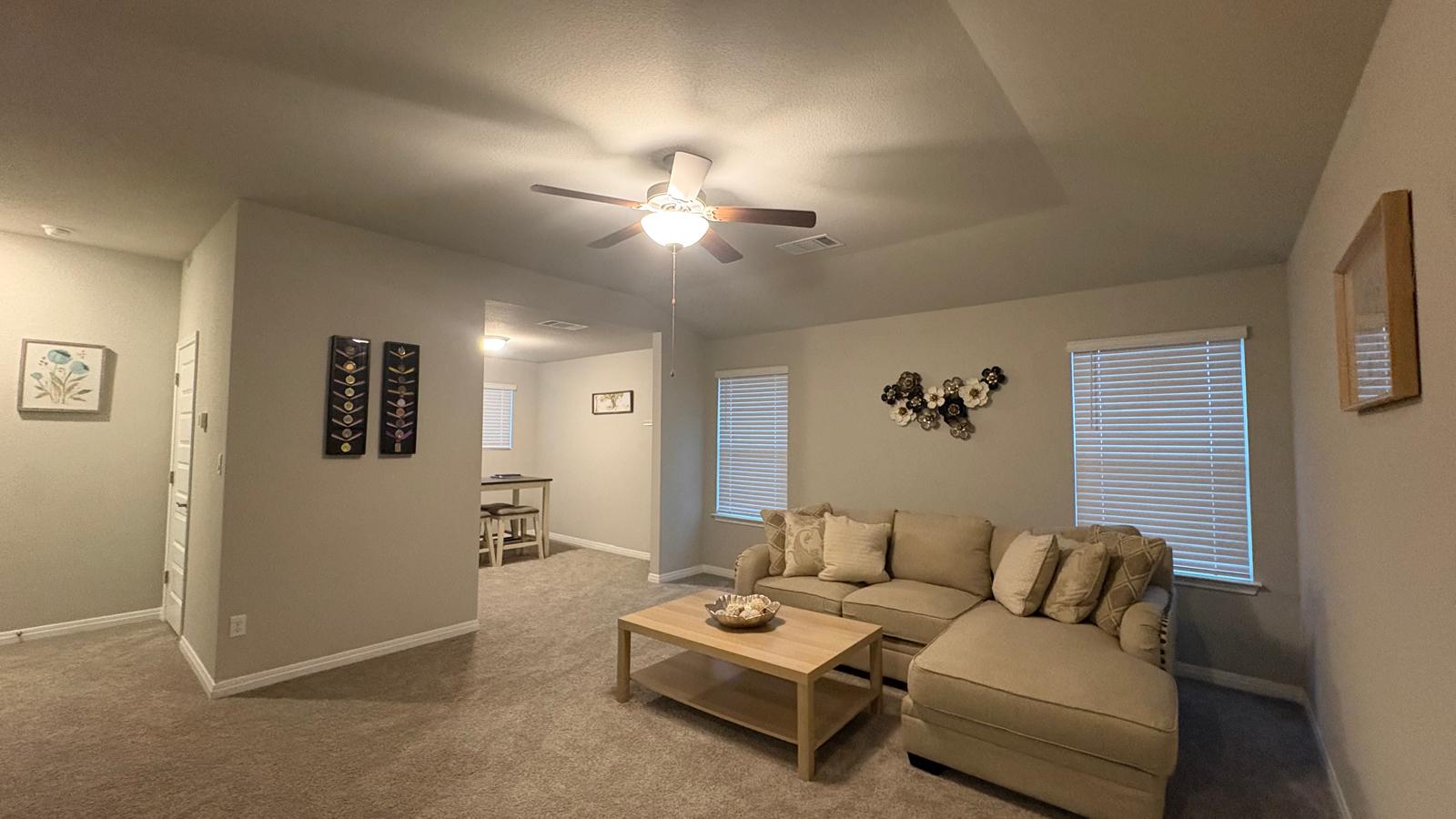 6511 Dragride Road Buda, TX 78610 - Photo 25 of 36 A comfortable sectional anchors this naturally illuminated living space with a distinct tray ceiling.