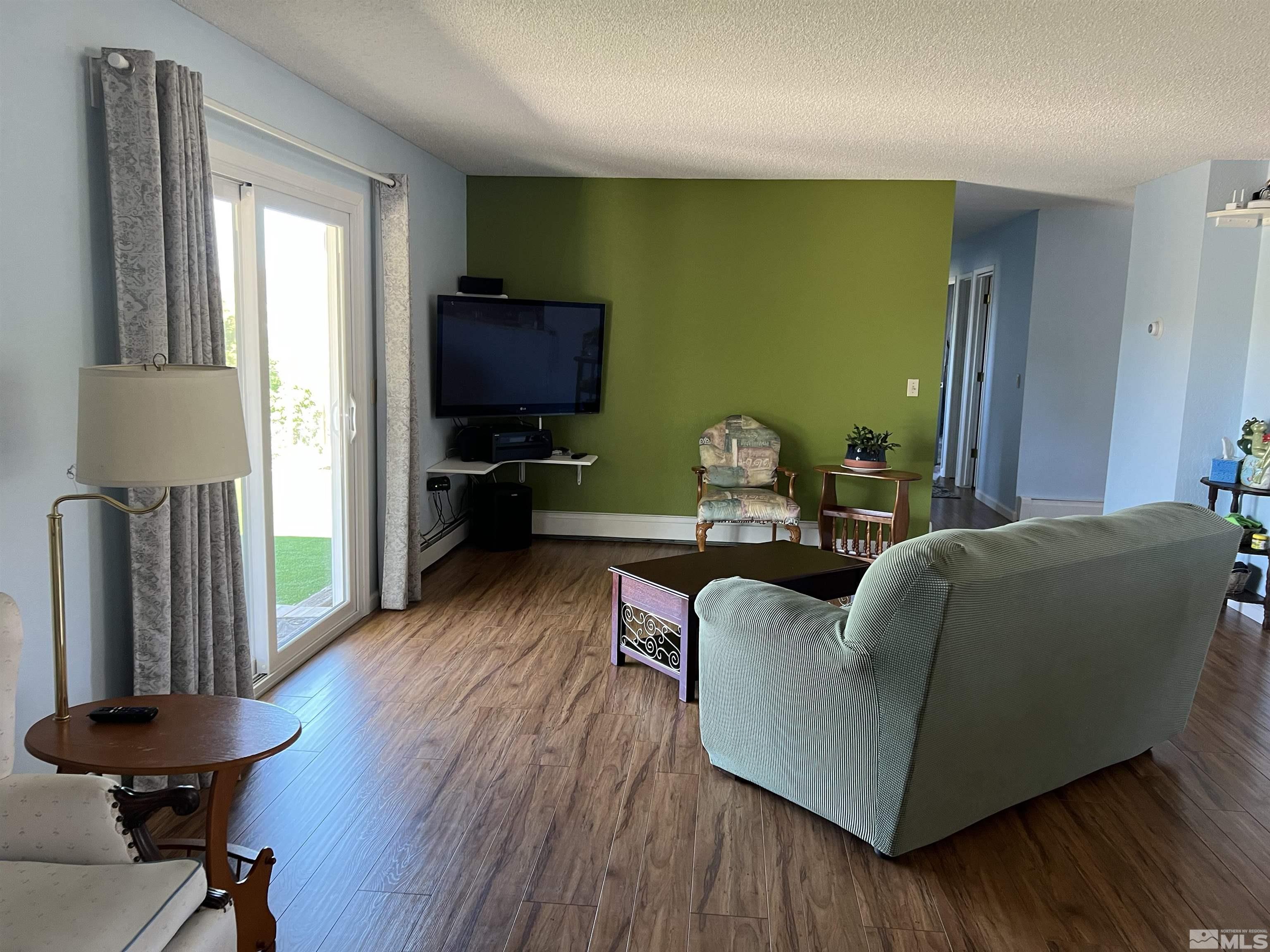 4936 Koenig Road Reno, NV 89506 - Photo 4 of 30 a living room with furniture and a flat screen tv