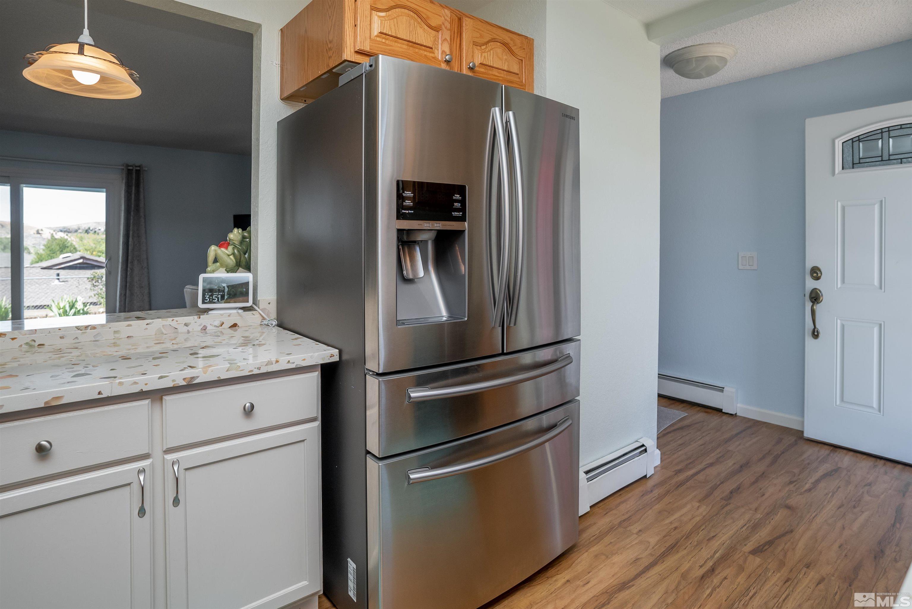 4936 Koenig Road Reno, NV 89506 - Photo 8 of 30 a kitchen with granite countertop stainless steel appliances a refrigerator and cabinets