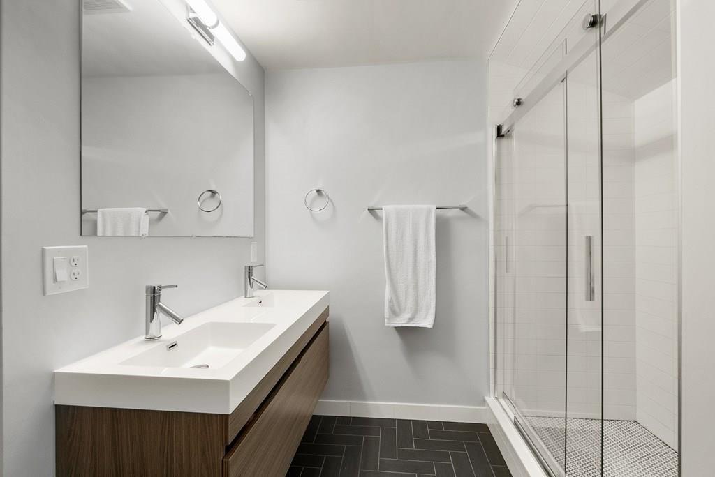 103 Stimson Street Boston, MA 02132 - Photo 13 of 26 a bathroom with a sink a mirror and a shower