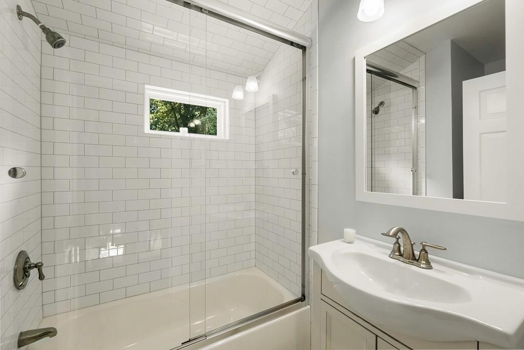 103 Stimson Street Boston, MA 02132 - Photo 17 of 26 a bathroom with a sink a mirror and a shower