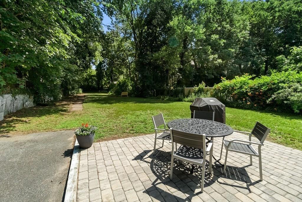 103 Stimson Street Boston, MA 02132 - Photo 19 of 26 a view of a table and chairs in the garden