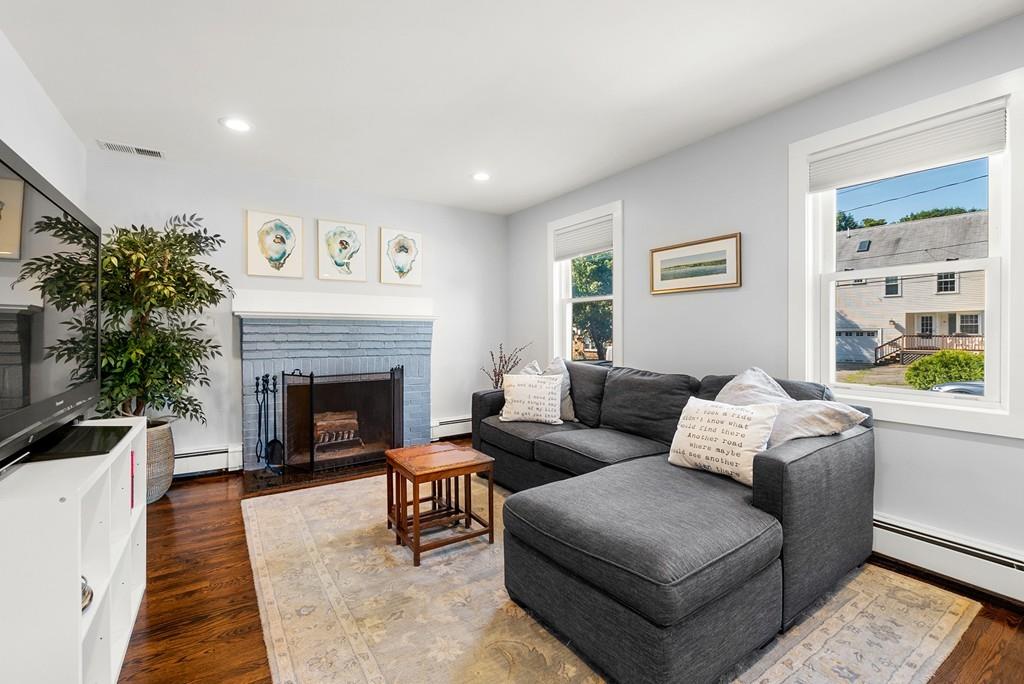 103 Stimson Street Boston, MA 02132 - Photo 5 of 26 a living room with furniture and a fireplace