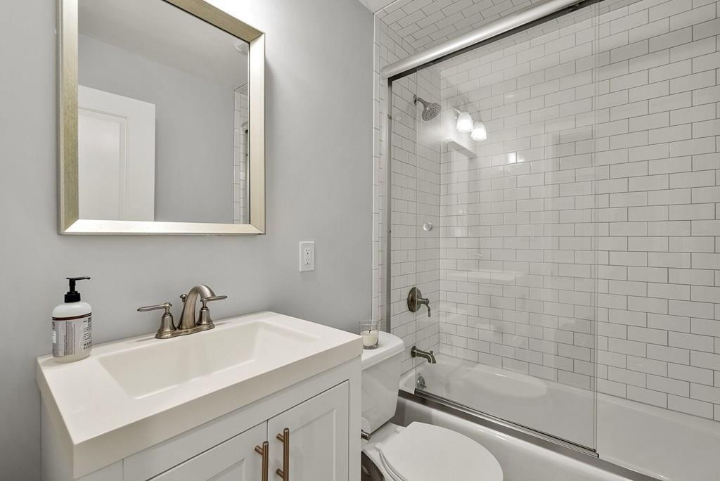 103 Stimson Street Boston, MA 02132 - Photo 10 of 26 a bathroom with a sink toilet a mirror and shower