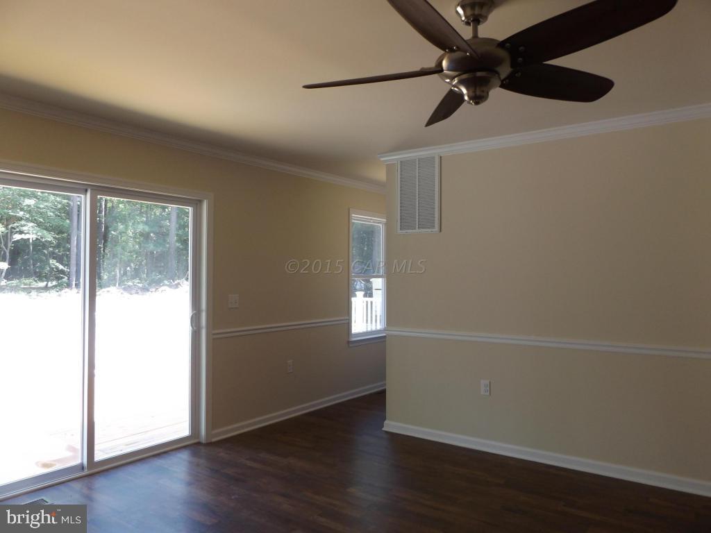27100 Mt Vernon Road Princess Anne, MD 21853 - Photo 14 of 22 an empty room with wooden floor and windows