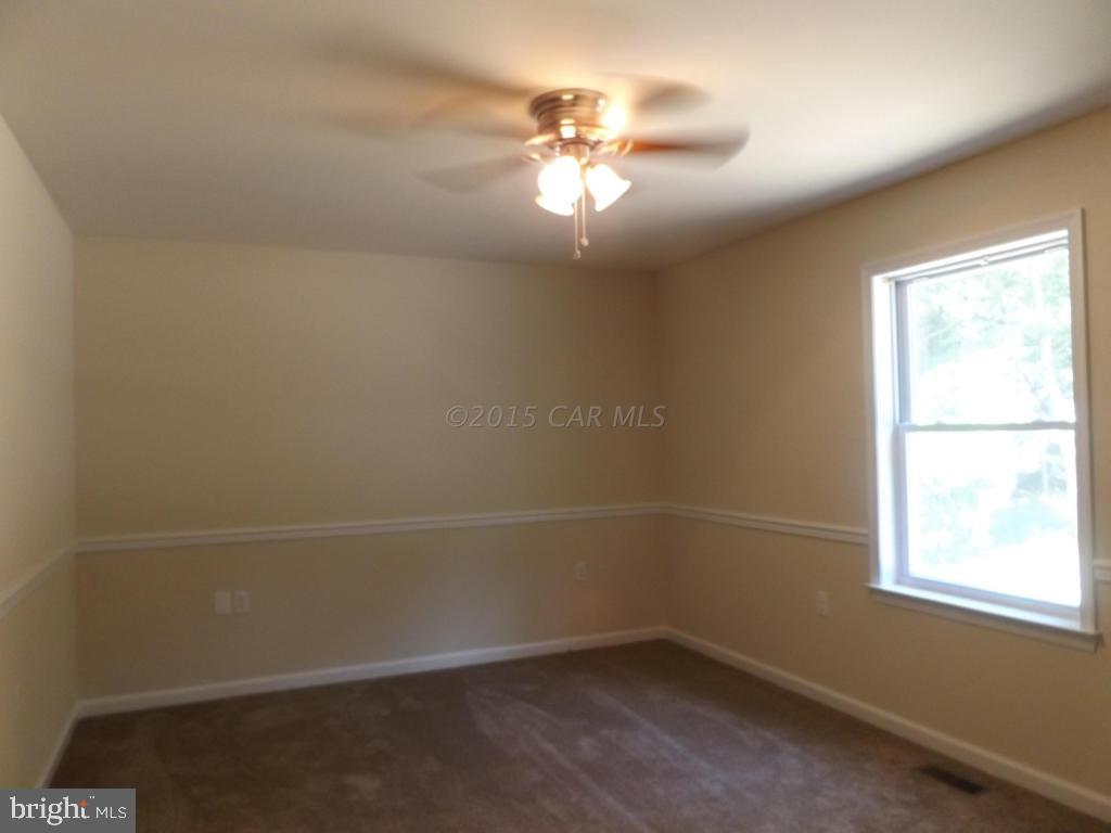 27100 Mt Vernon Road Princess Anne, MD 21853 - Photo 19 of 22 an empty room with a window and a fan