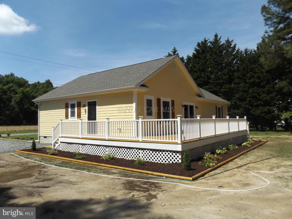 27100 Mt Vernon Road Princess Anne, MD 21853 - Photo 4 of 22 a front view of a house with a yard