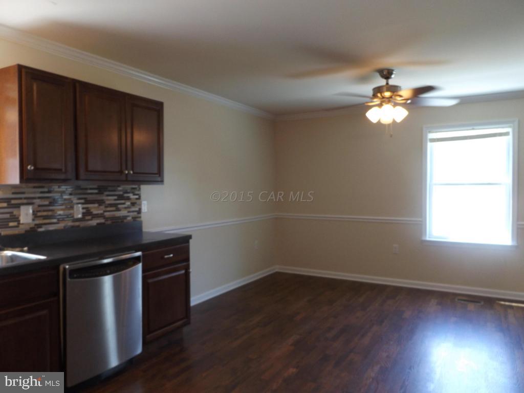 27100 Mt Vernon Road Princess Anne, MD 21853 - Photo 10 of 22 a kitchen with a stove a sink and a window