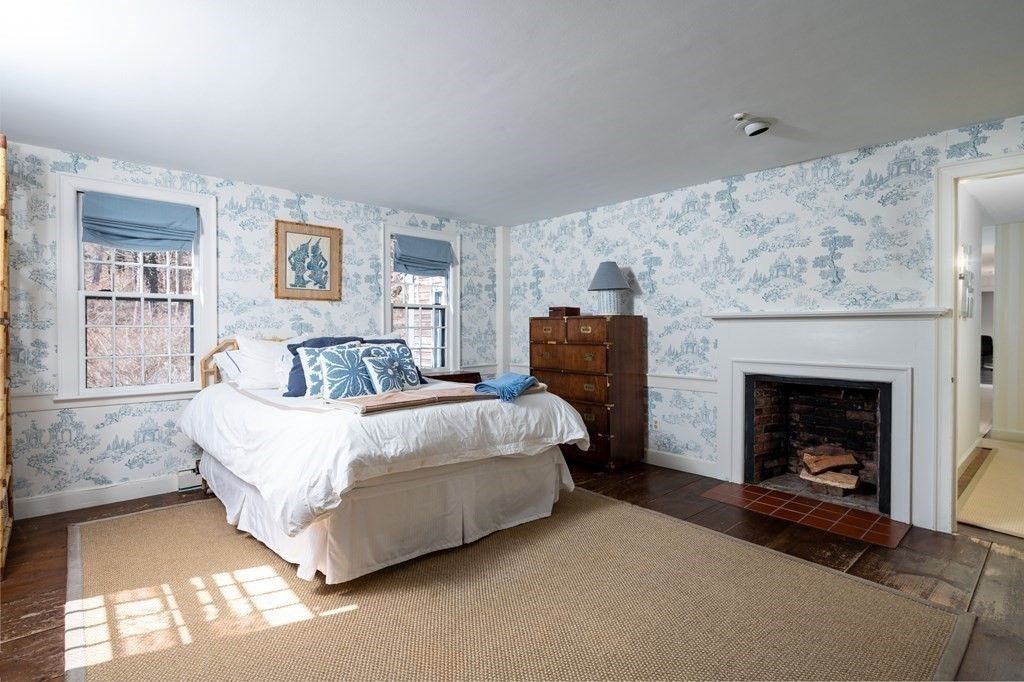 35 Lantern Lane Cohasset, MA 02025 - Photo 11 of 20 a spacious bedroom with a bed and a fireplace